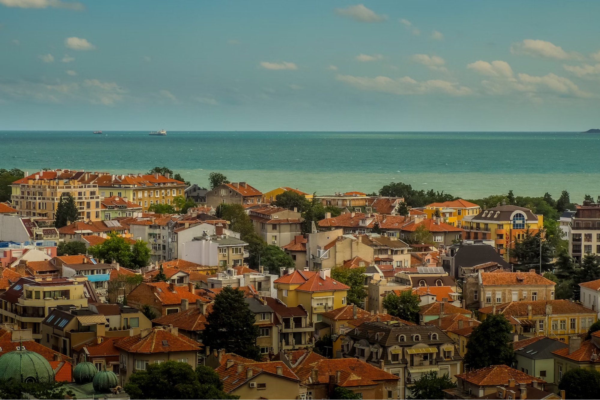 Panoramic view of Burgas with red rooftops and the Black Sea in the background