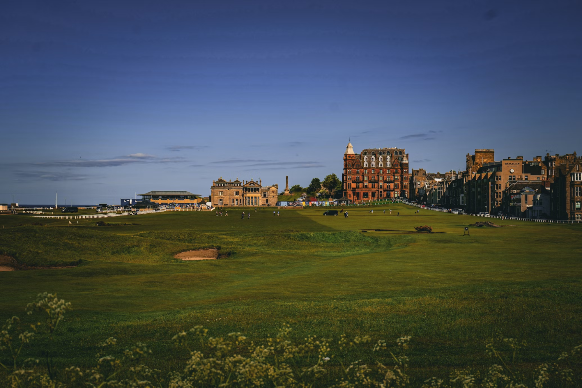 View of St Andrews Old Course and historic buildings at sunset