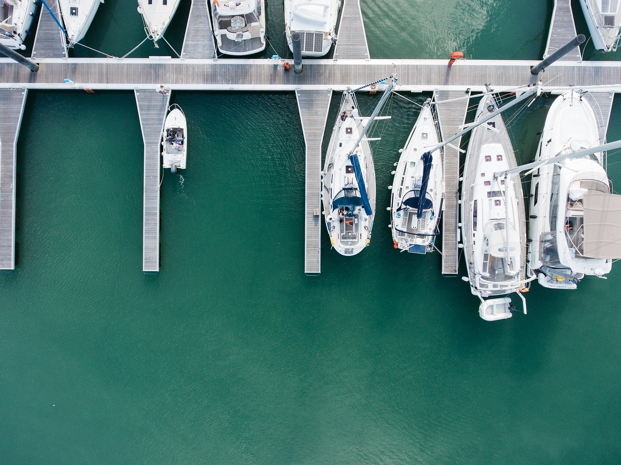 Aerial view of yachts docked at a marina in turquoise water