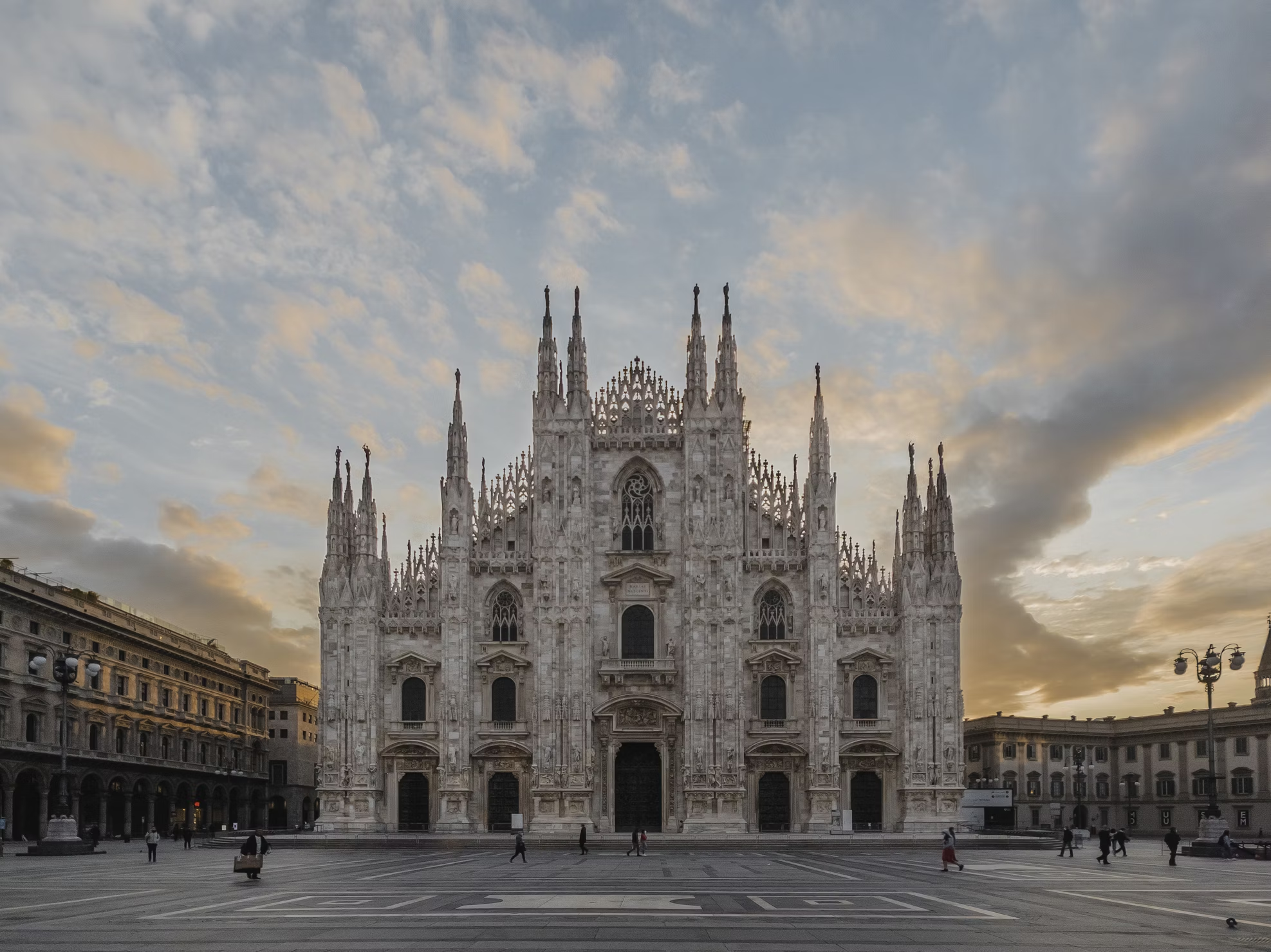Duomo di Milano at sunset with people in the square