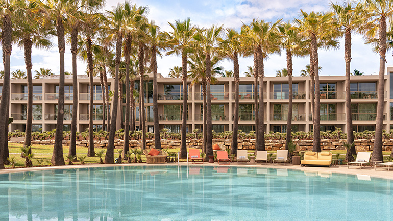 Kimpton Atlântico Algarve hotel with palm trees and outdoor pool