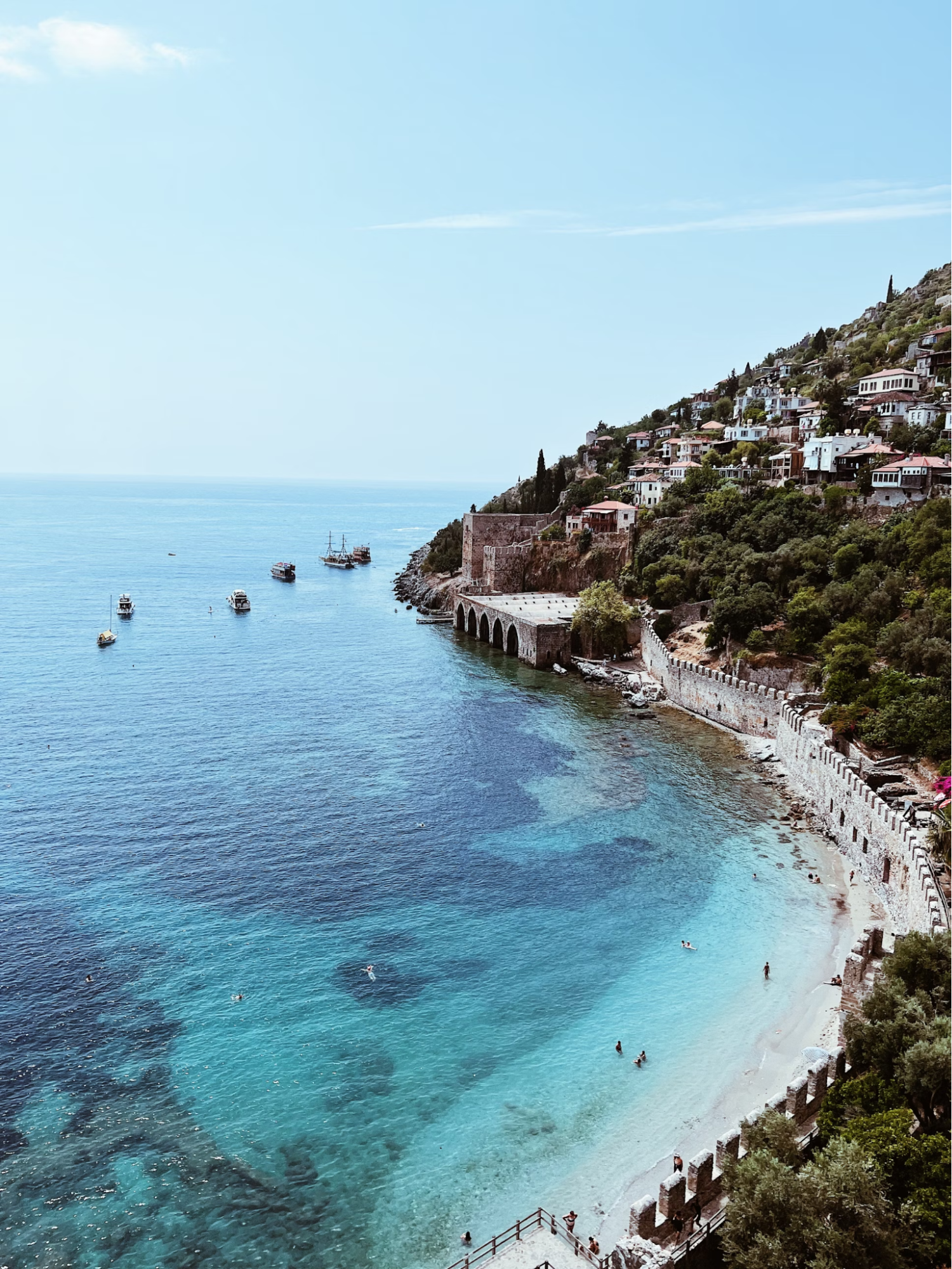 View of Alanya coast with historic towers and clear sea