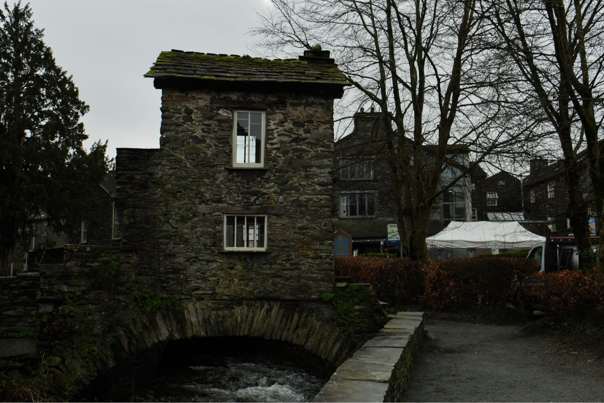 Historic stone Bridge House in Ambleside crossing over a stream