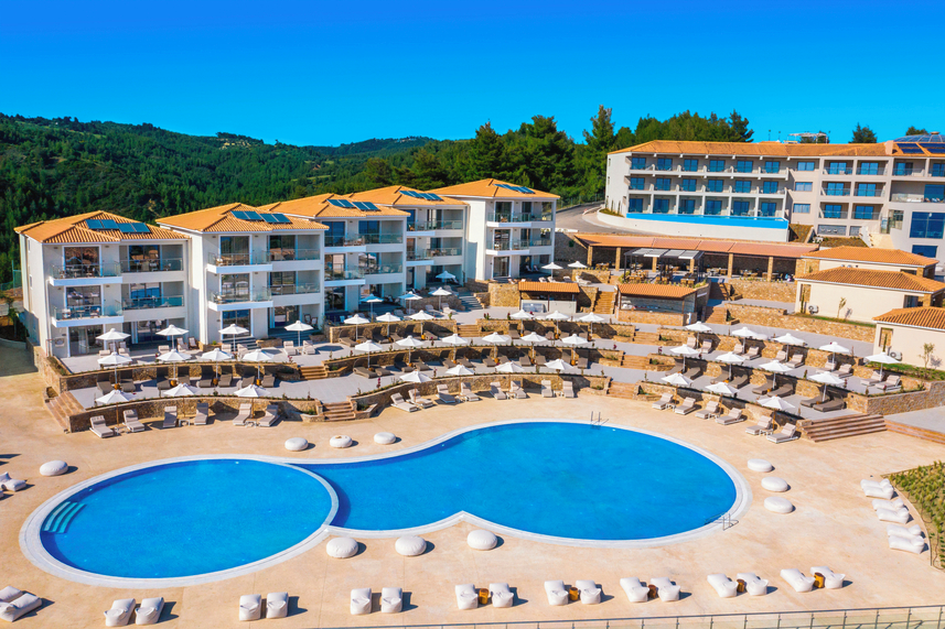Outdoor view of Ajul Luxury Hotel & Spa Resort in Halkidiki, Greece, with pool and terrace seating