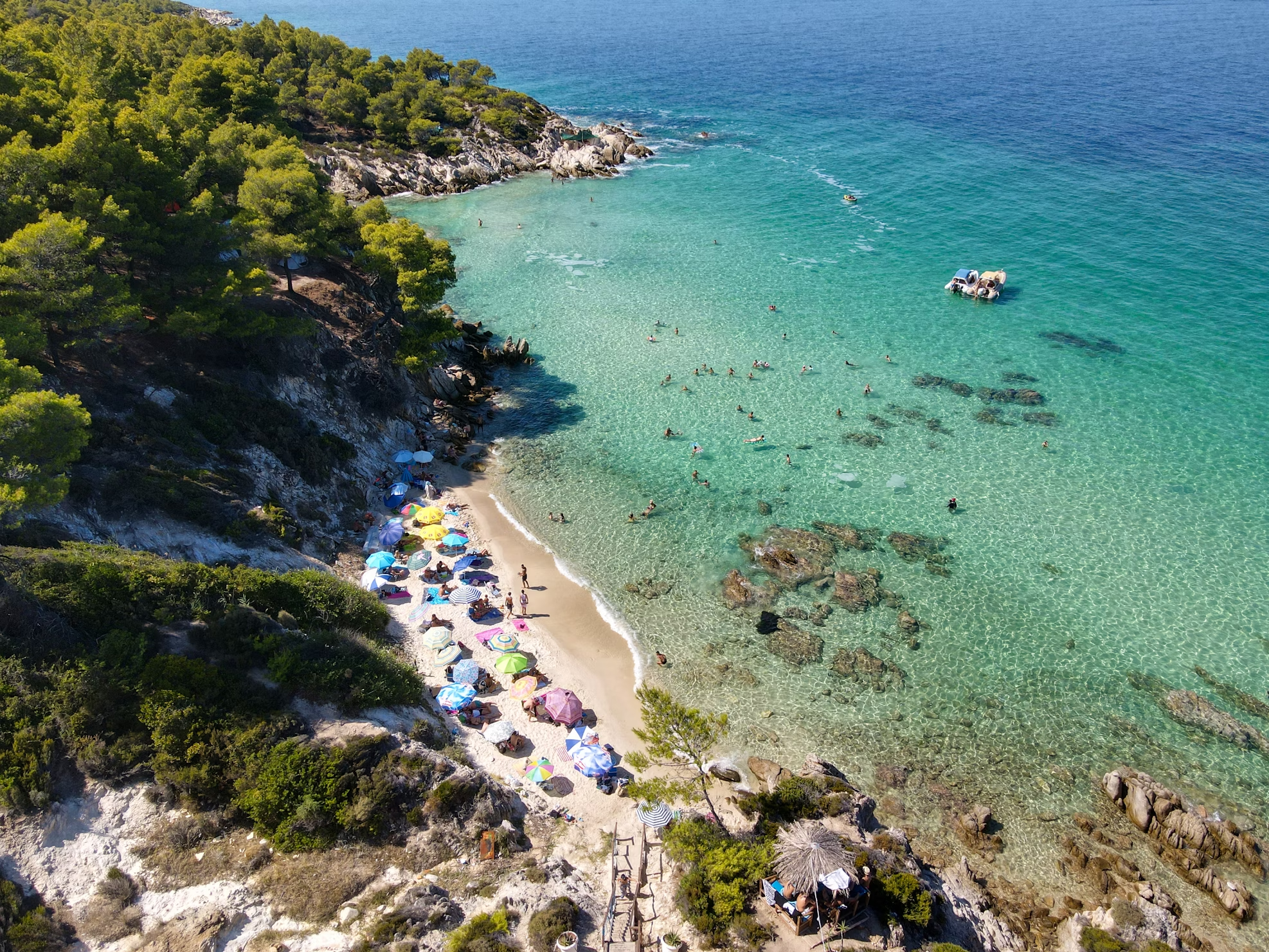 A group of people enjoying a sunny beach in Halkidiki, Greece, capturing a relaxed and joyful atmosphere