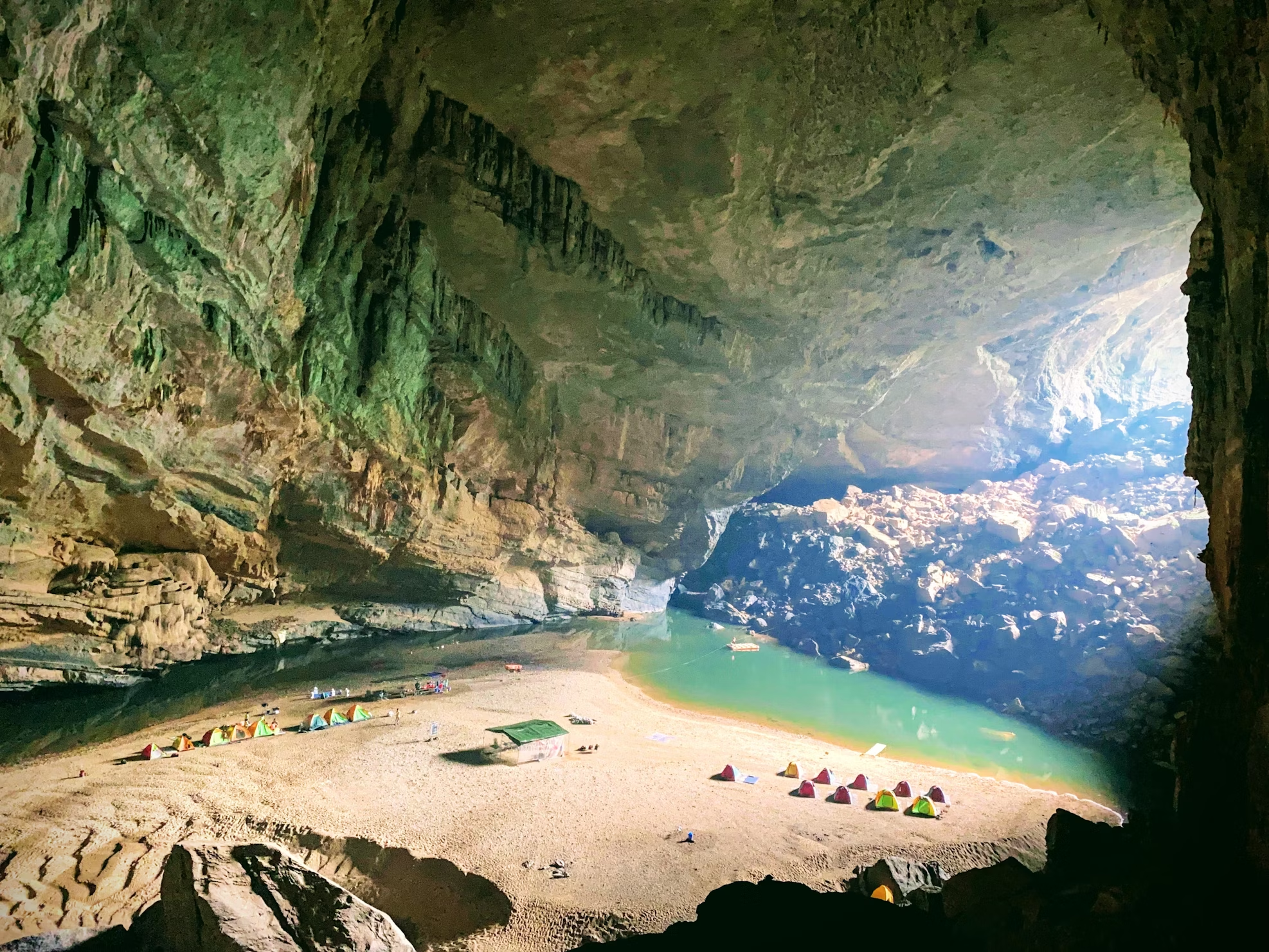 Campsite inside Son Doong Cave with river and tents