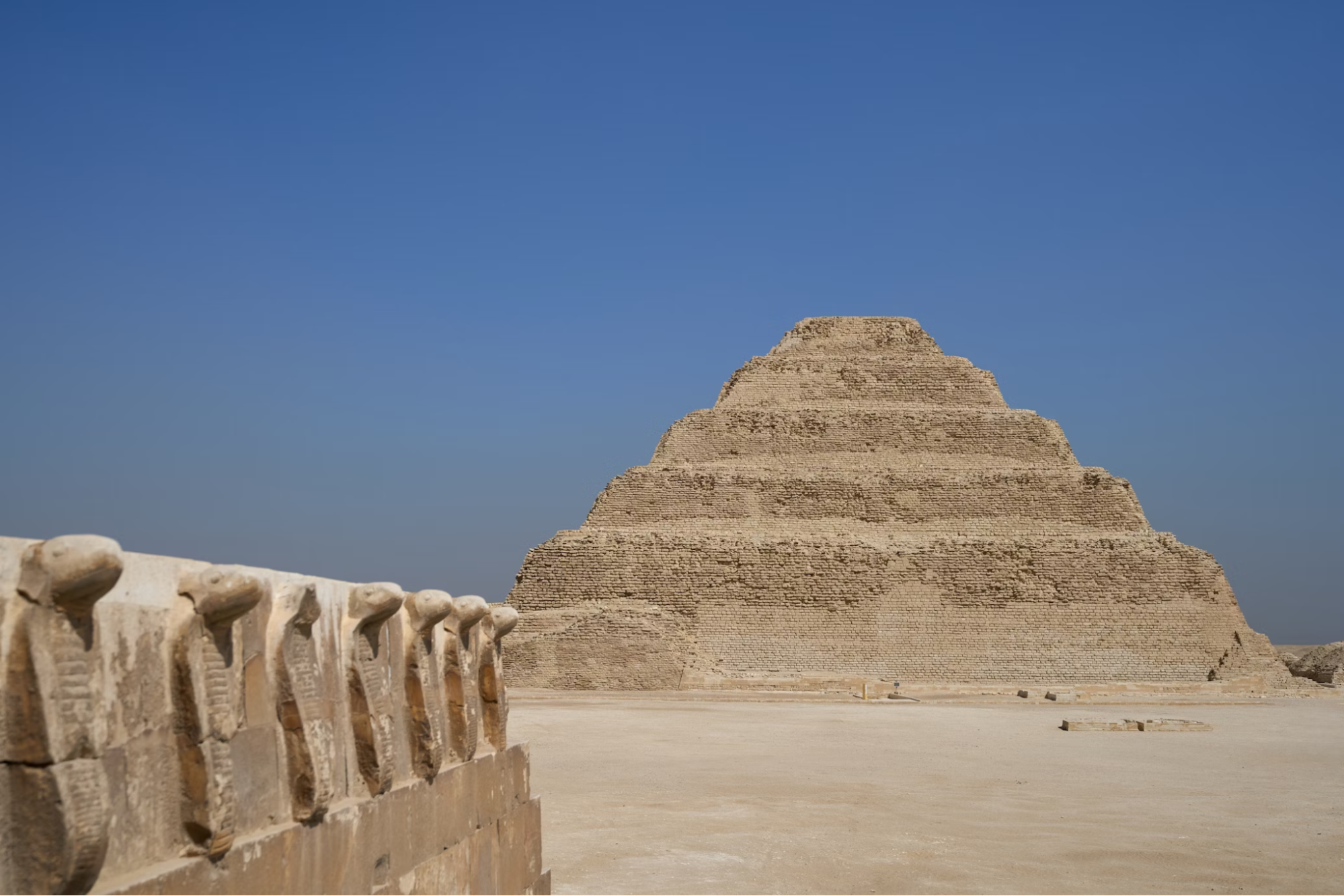 Step Pyramid of Djoser at Saqqara under clear blue sky