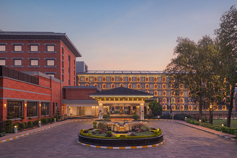 Hotel entrance with garden and traditional Nepalese architecture in Kathmandu