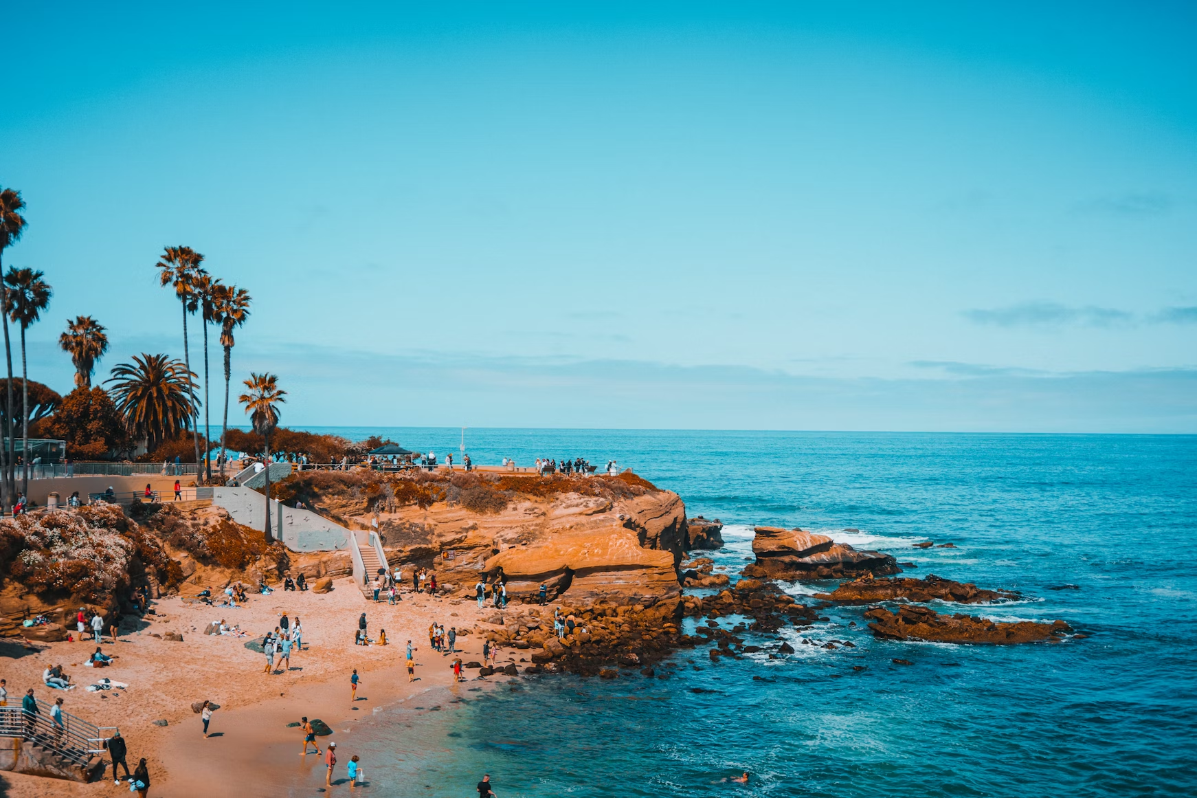 Visitors enjoying a beach and rocky shoreline in San Diego