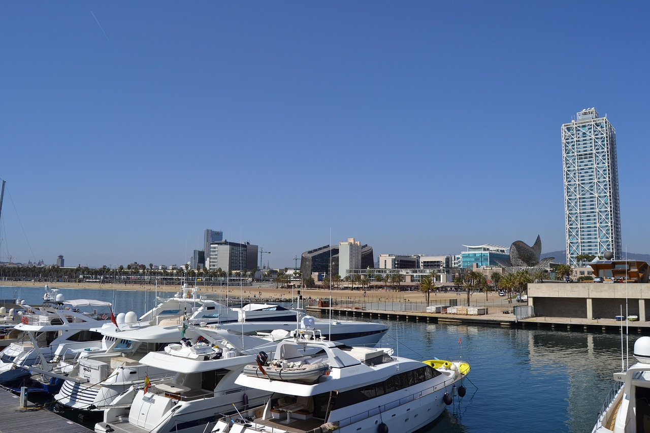 Yachts docked at Port Olímpic in Barcelona on a sunny day