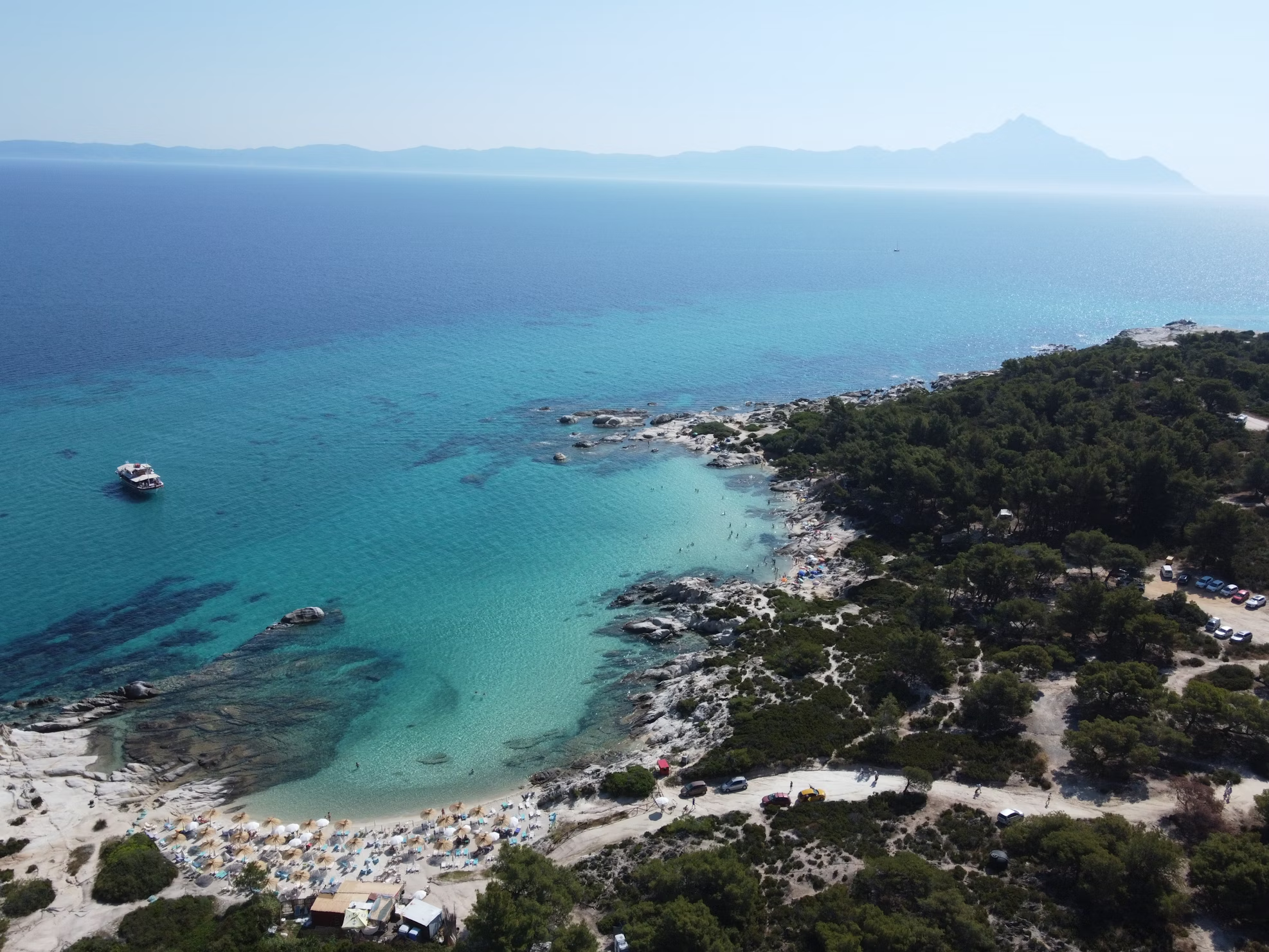 Aerial view of Kavourotrypes Beach in Halkidiki, Greece, with turquoise waters and sunbathers