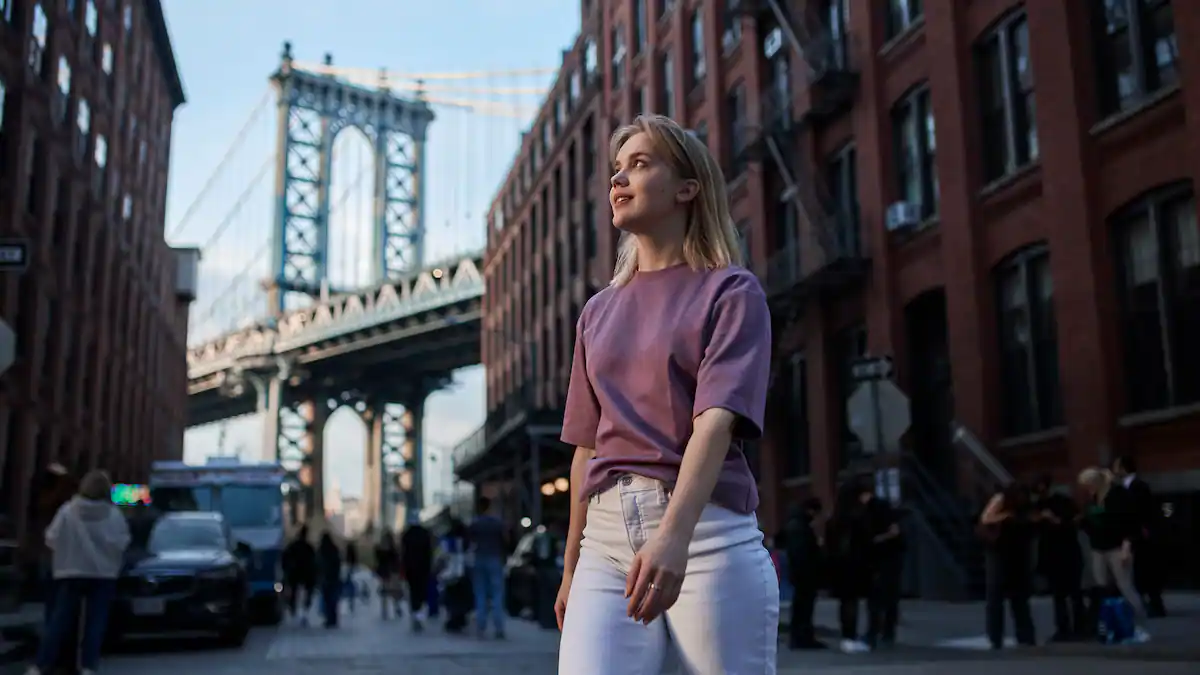 Woman walking in Dumbo, Brooklyn, with Manhattan Bridge in the background