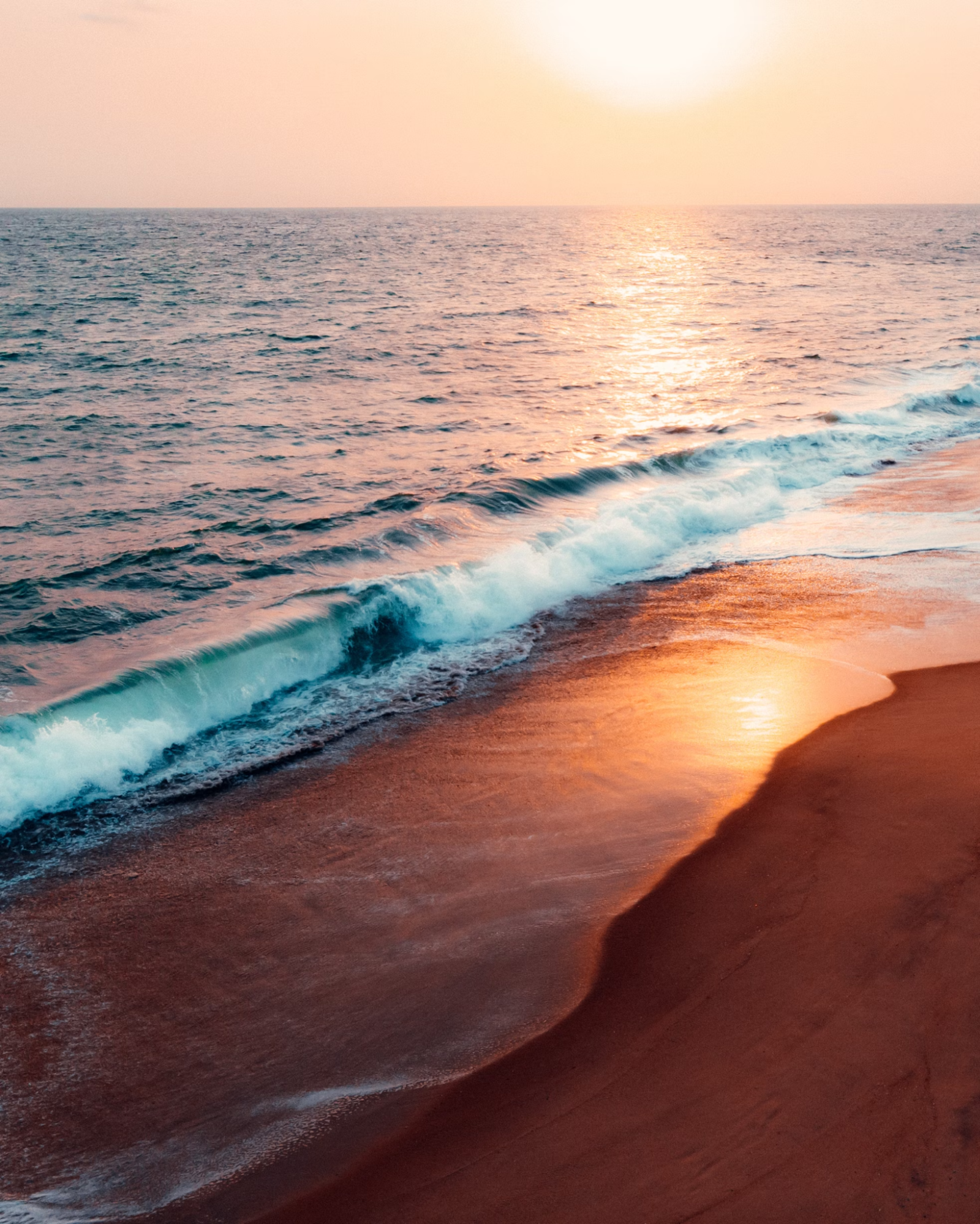 Waves rolling onto Elegushi Beach at sunset