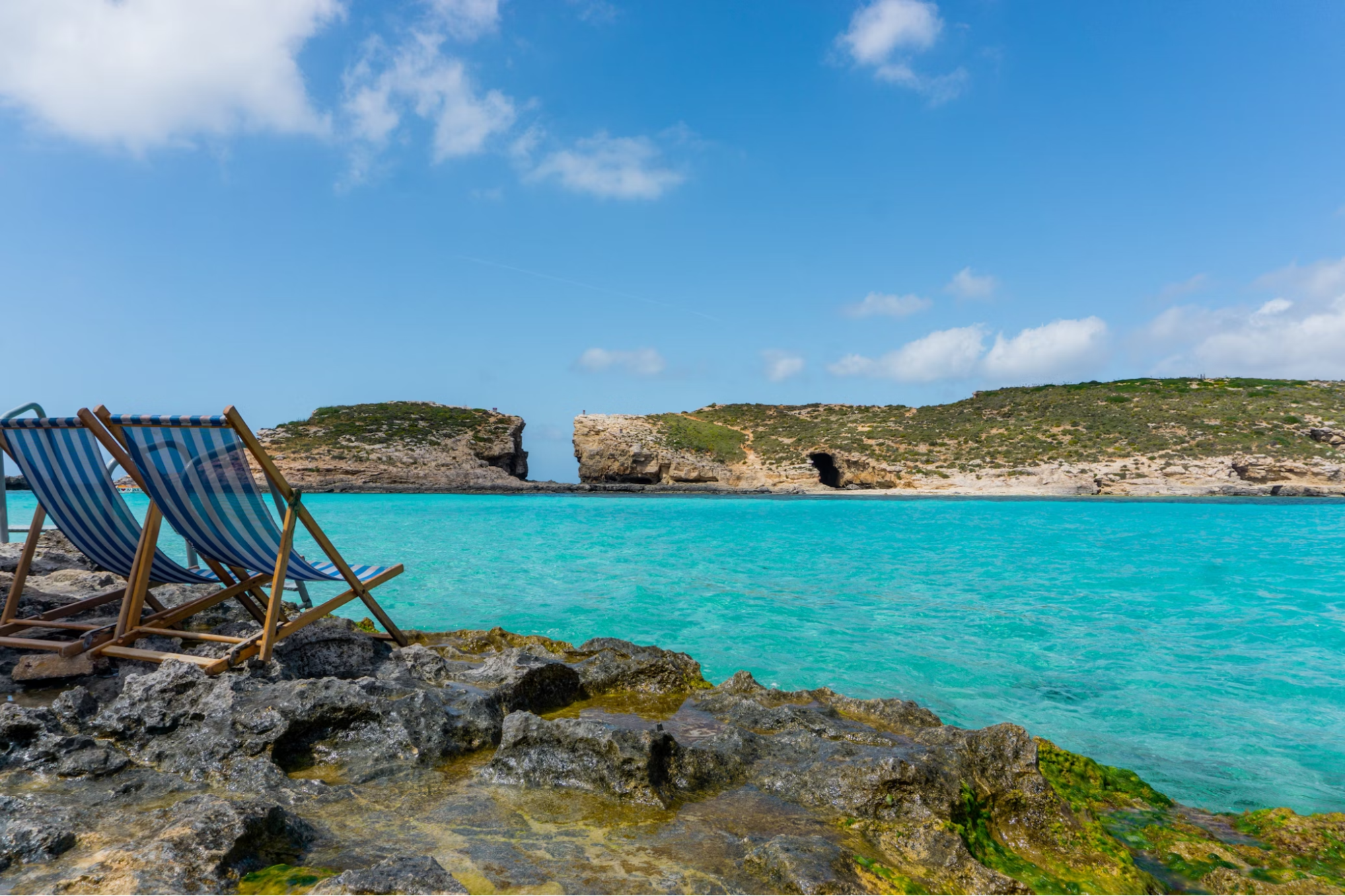 Deck chairs overlooking the Blue Lagoon on Comino Island, Malta
