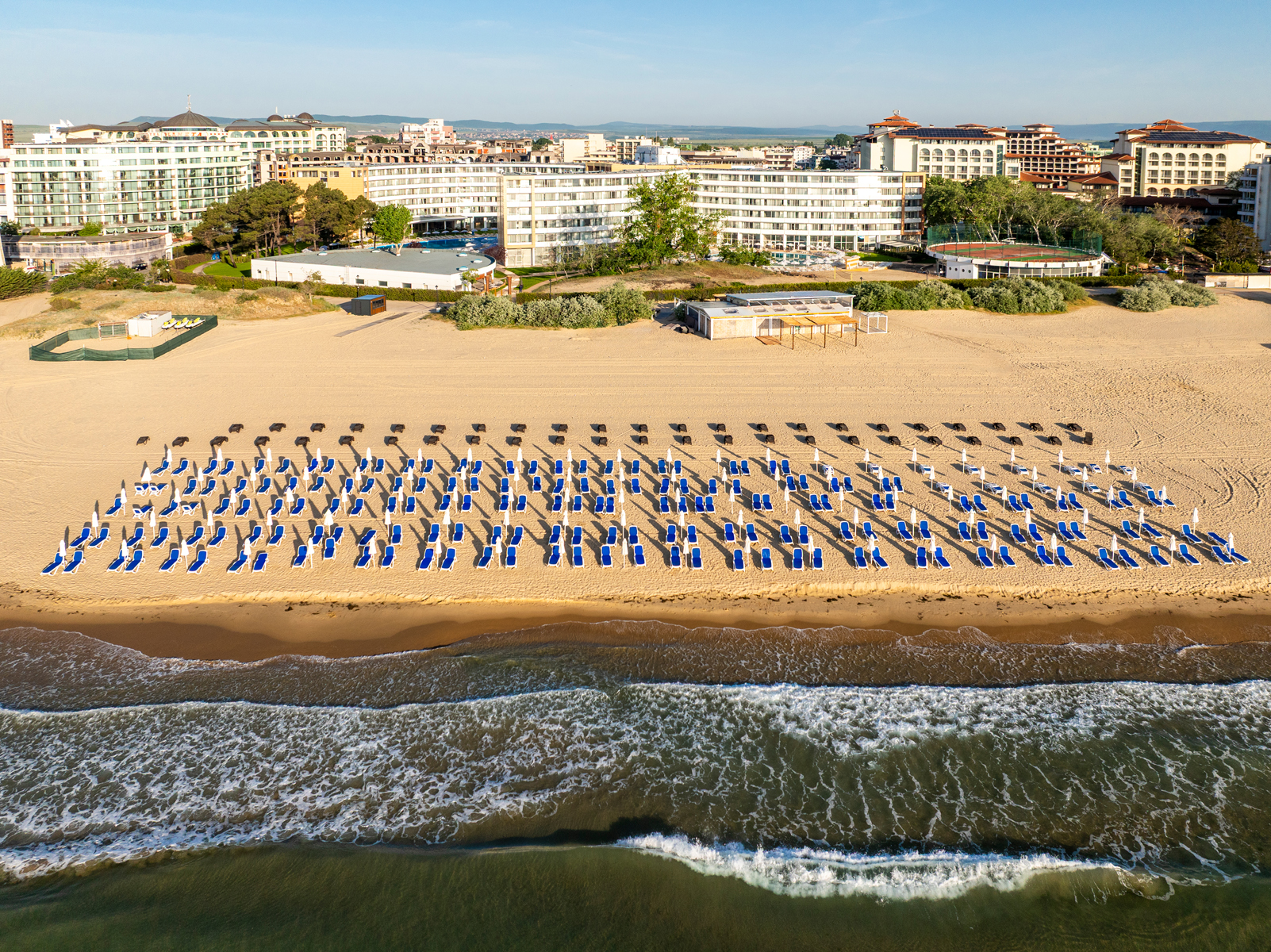 Aerial view of AluaSoul Sunny Beach resort with sunbeds lined up on the sand