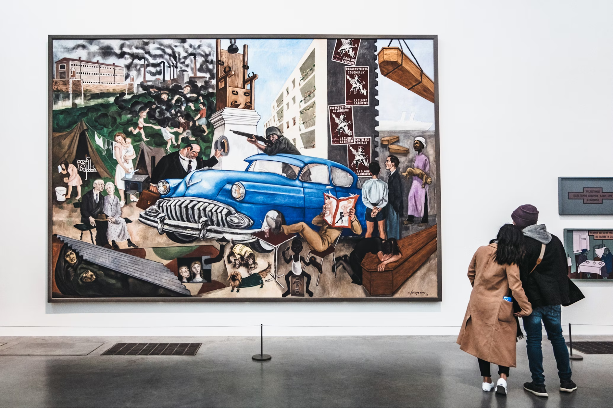 Visitors observing a large colorful painting at Tate Modern art museum in London