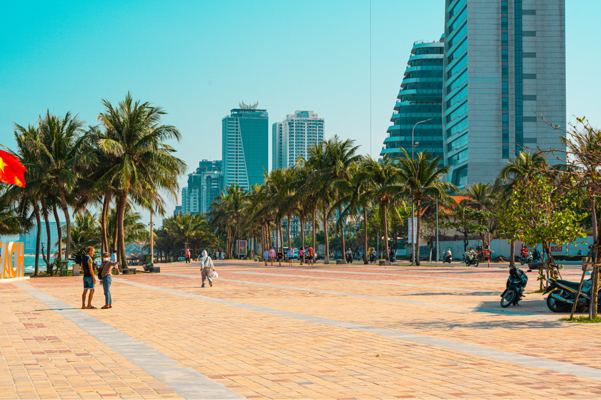 Beachfront promenade in Da Nang, Vietnam with modern buildings and palm trees