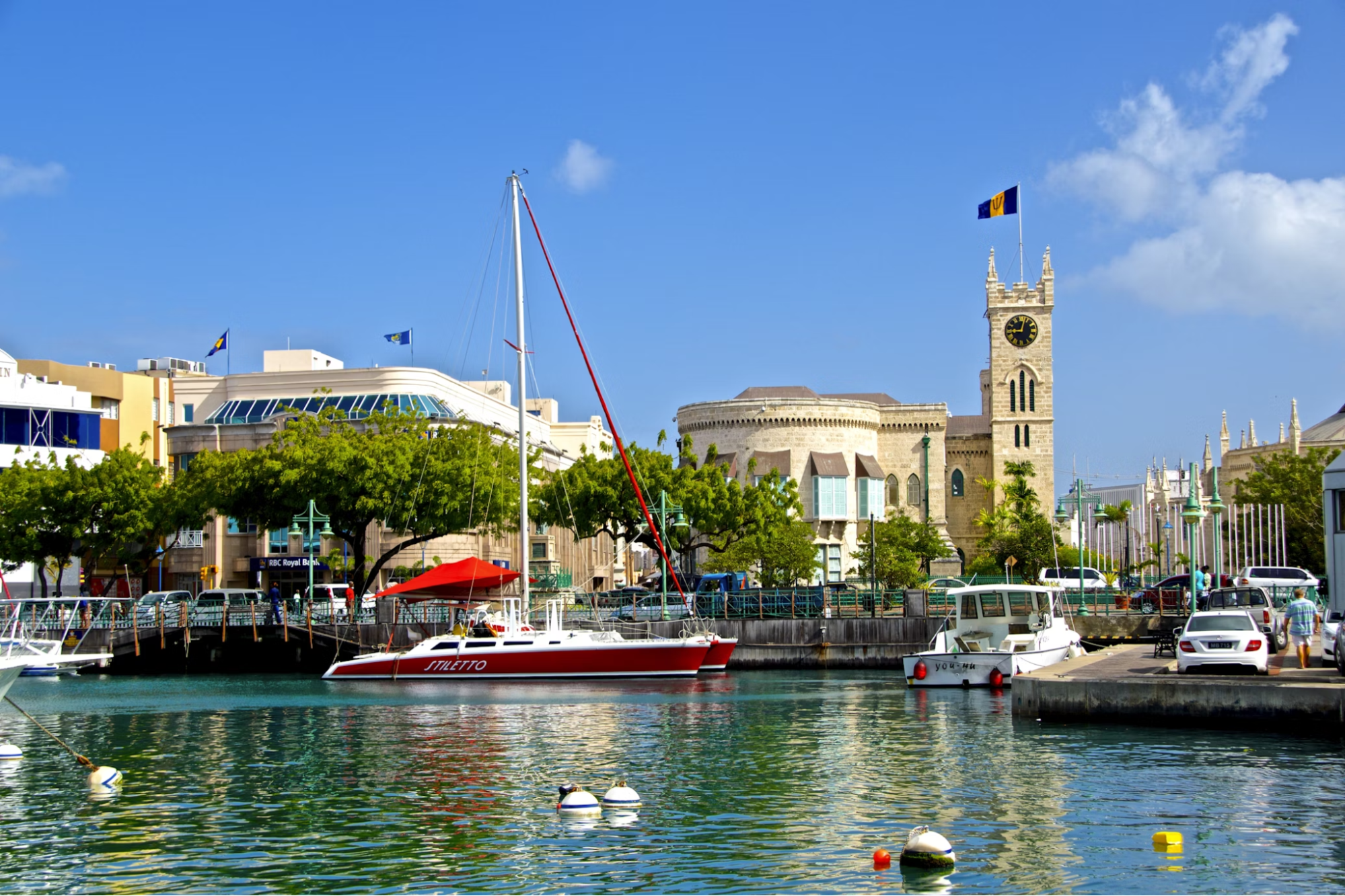 Bridgetown waterfront with boats and historic buildings under blue sky