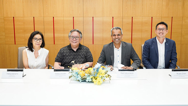 People at signing table during Kimpton Ubud hotel partnership agreement