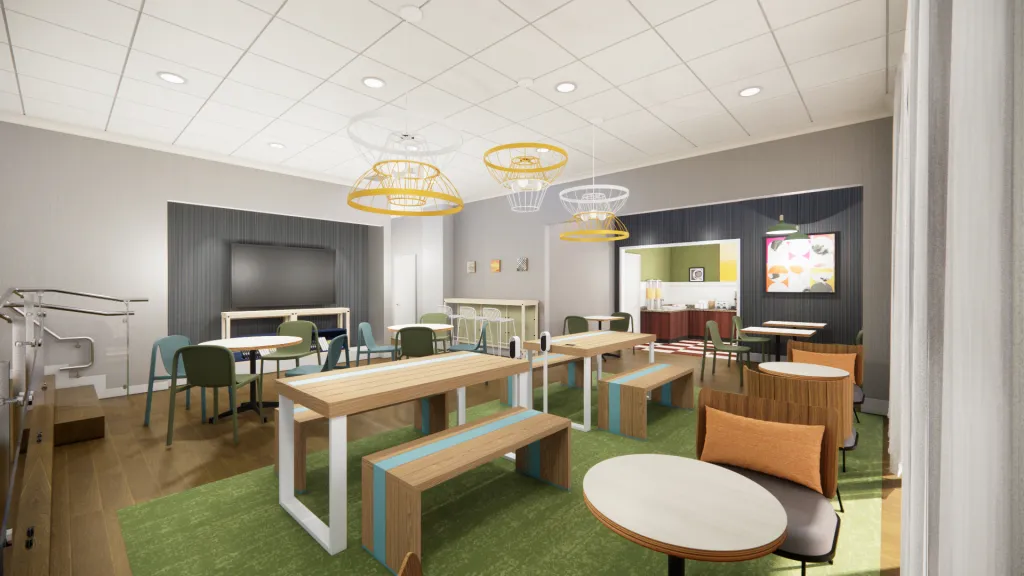 Common area with seating and tables inside a modern hotel