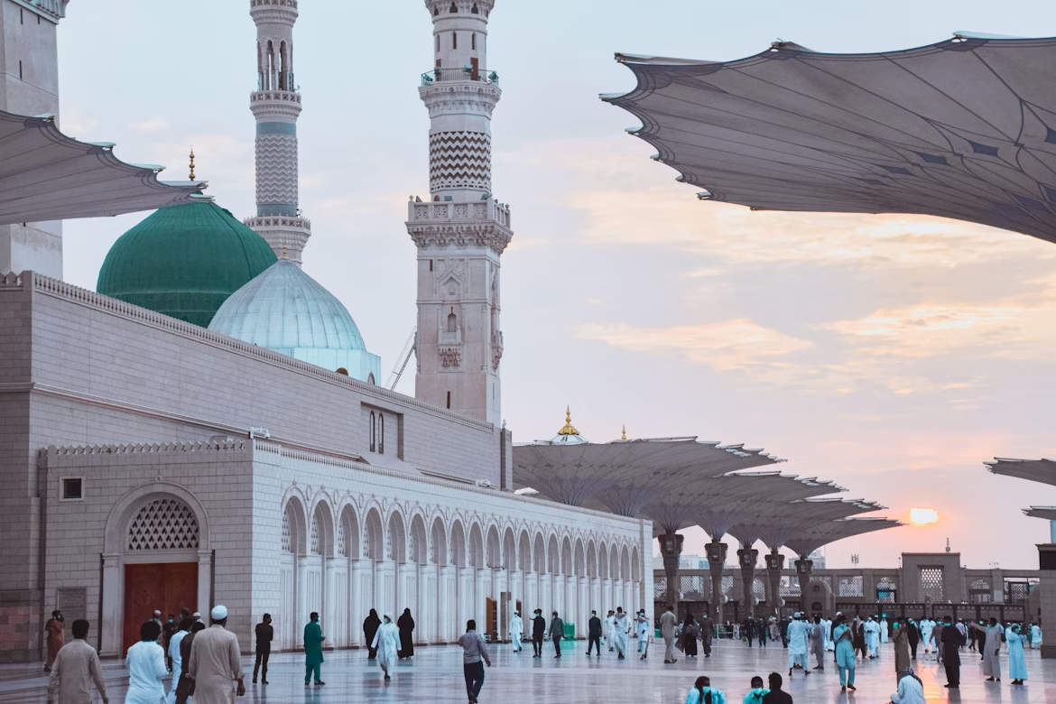 Pilgrims walk near the Prophet’s Mosque in Madinah at sunset