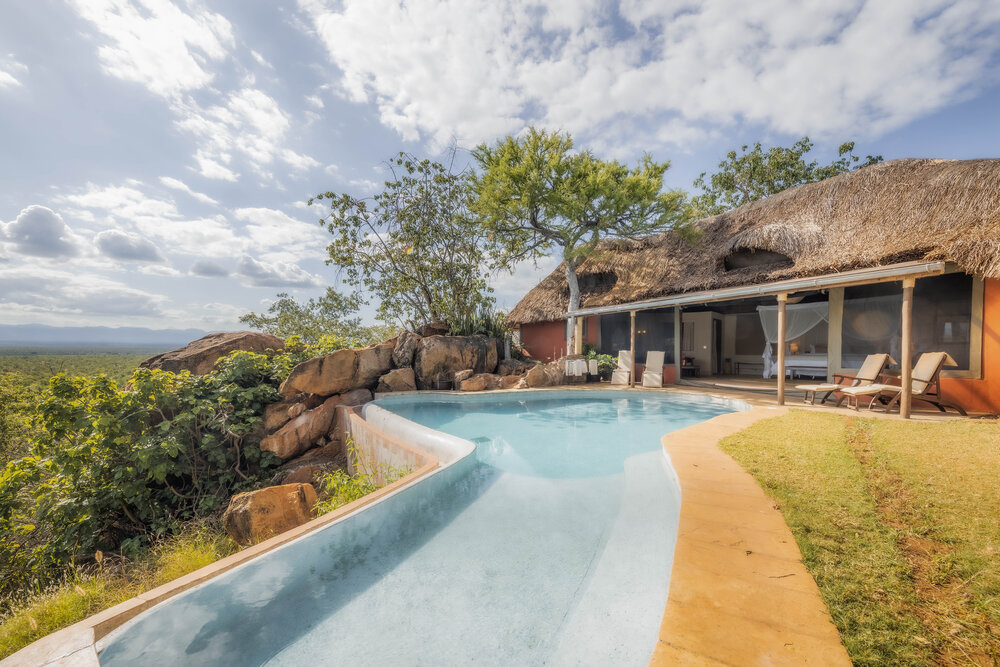 Private safari lodge with infinity pool overlooking a natural landscape