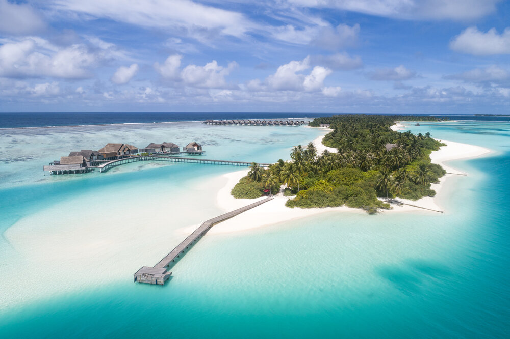 Aerial view of Niyama Private Islands Maldives with white sand beaches, turquoise water, and overwater villas