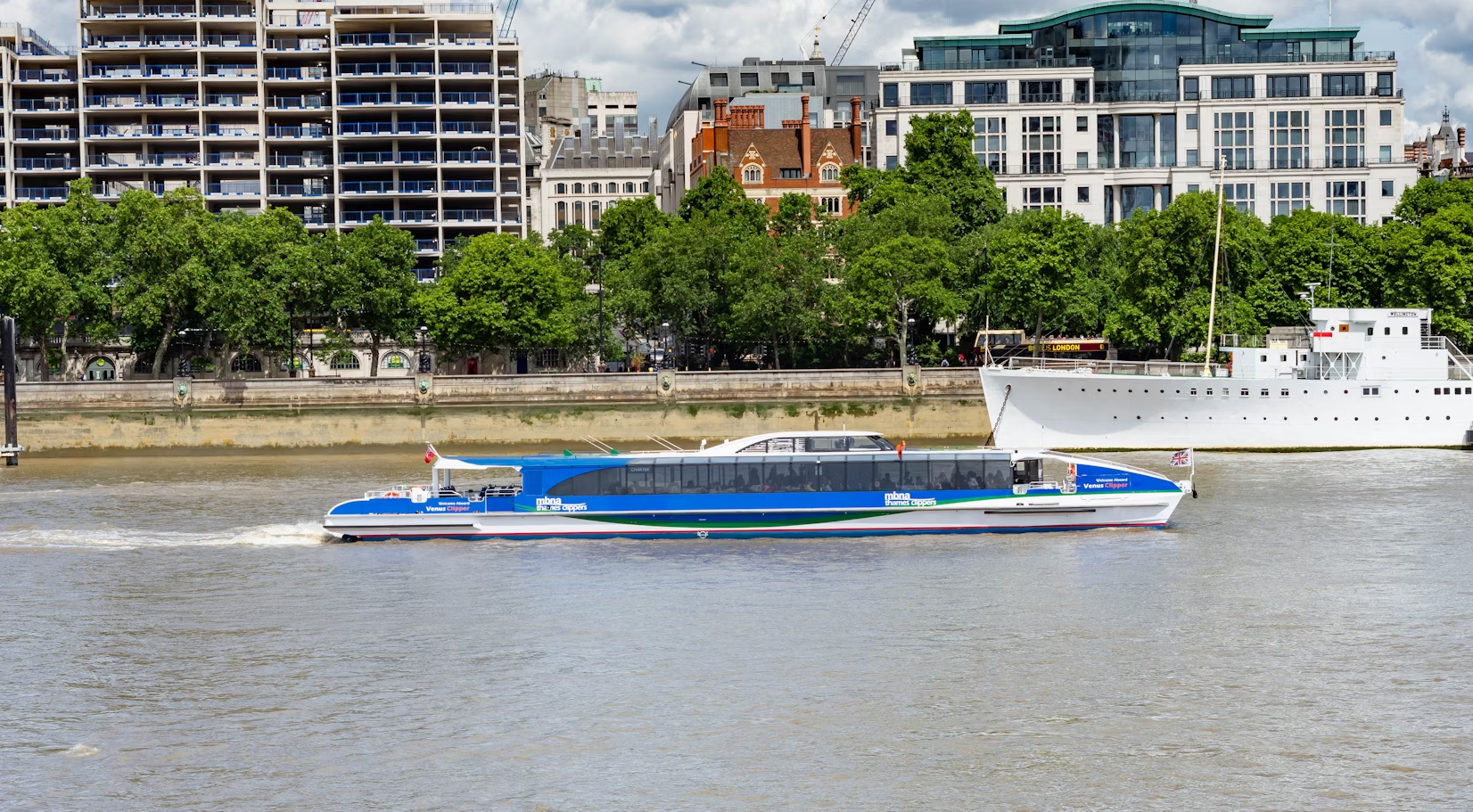 River bus navigating the Thames near central London buildings