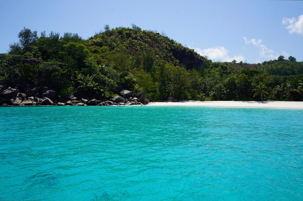 Anse Georgette beach with turquoise water and lush greenery in Seychelles