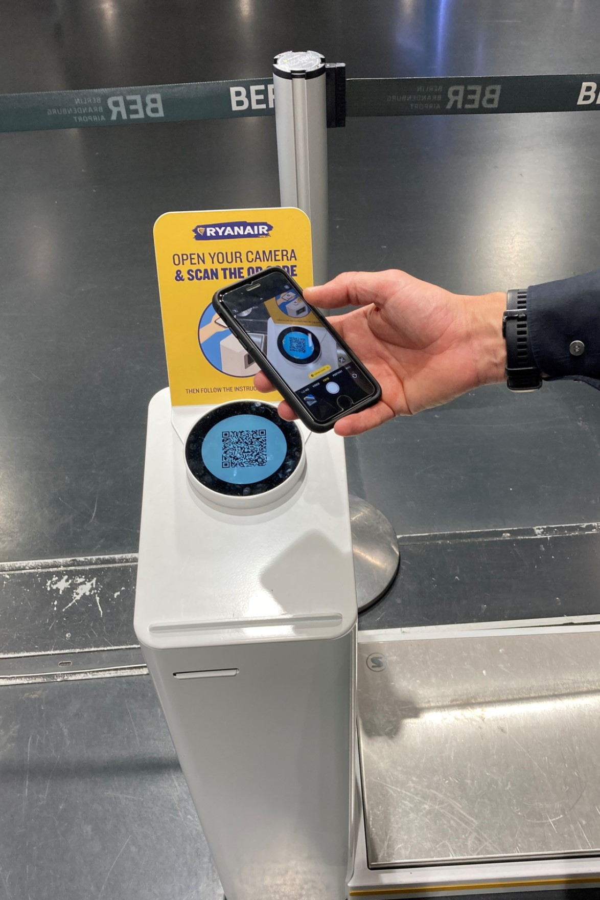 Passenger scans Ryanair QR code at Berlin Airport self-service baggage kiosk
