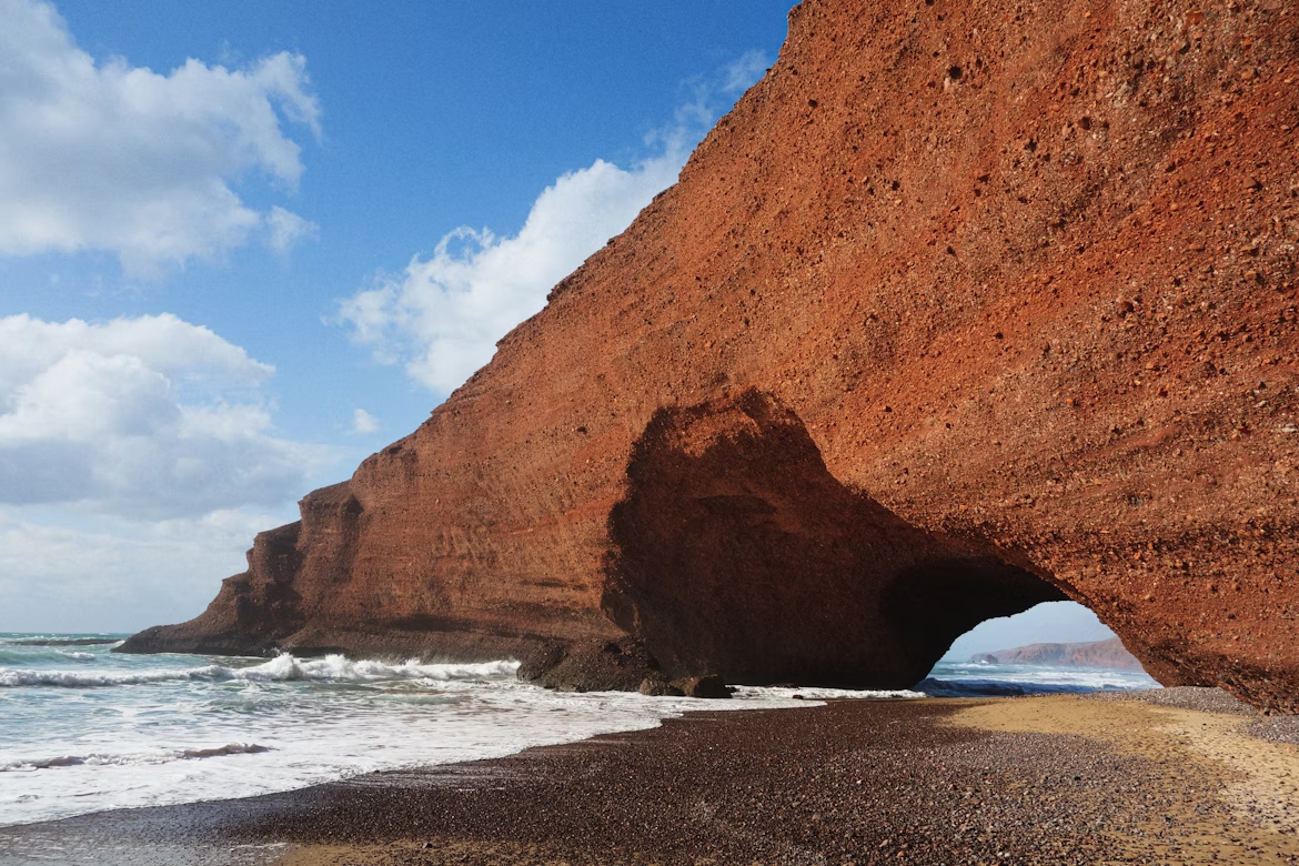 Natural red rock arch on Legzira Beach, Morocco