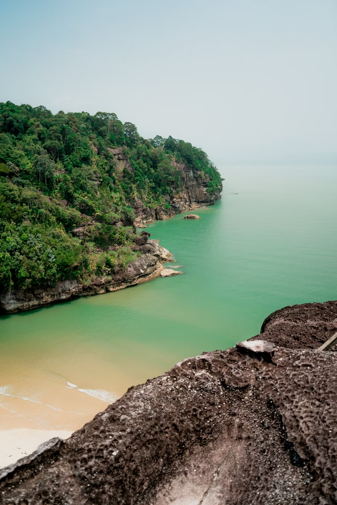 Coastal cliffs and green waters at Bako National Park in Borneo