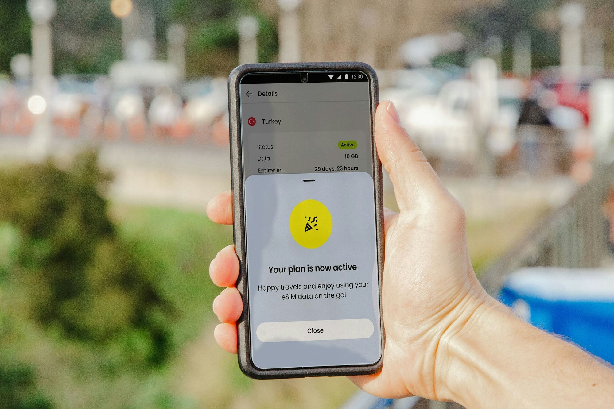 Hand holding smartphone showing active eSIM travel data plan