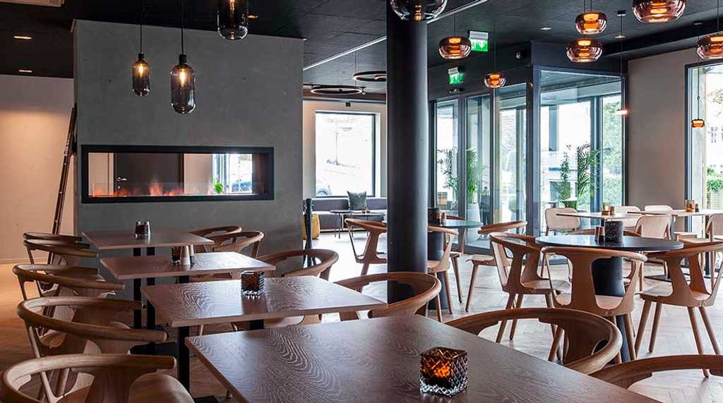 Modern dining area inside Scandic Victoria Florø with natural light and contemporary design