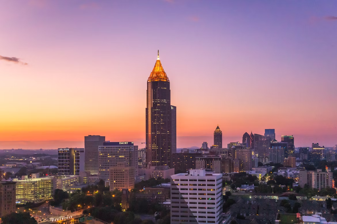 Downtown Atlanta skyline at sunset with tall buildings and city lights