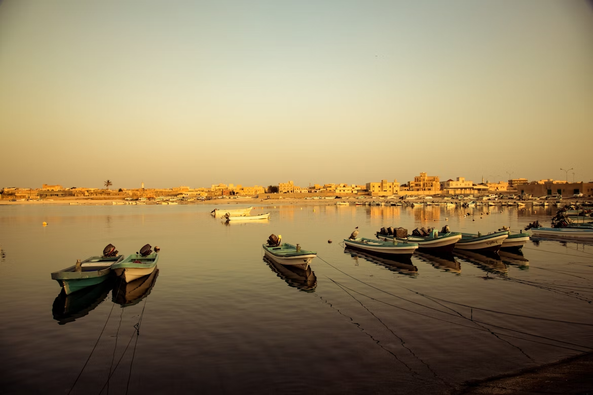 Traditional fishing boats in Salalah, Oman at sunset