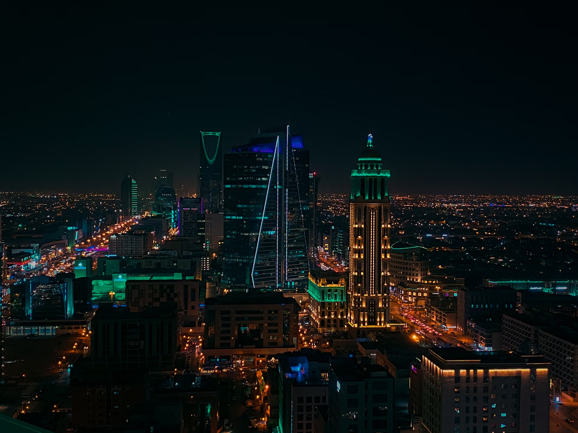 Riyadh city skyline at night with illuminated skyscrapers and busy streets