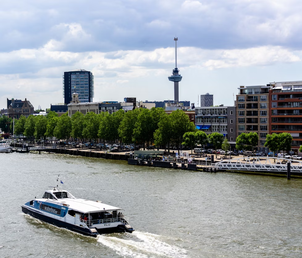 Waterbus on the river with Euromast tower in Rotterdam in the background