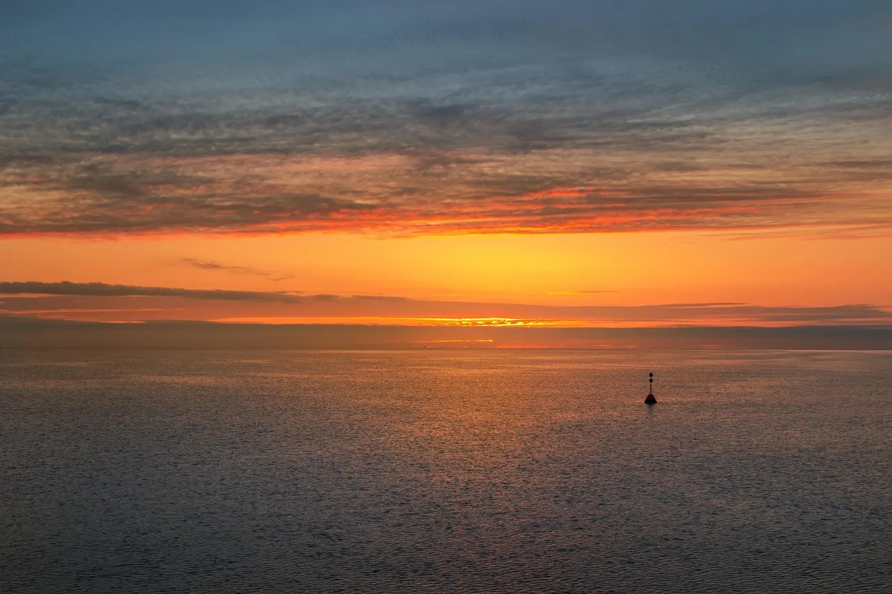 Sunset over the Baltic Sea with a small buoy in view
