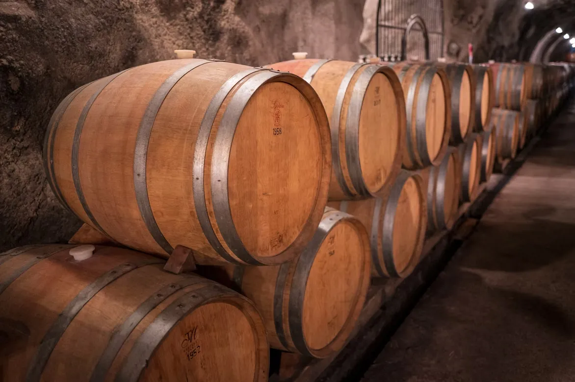 Wooden wine barrels stored in an underground cellar in Moldova