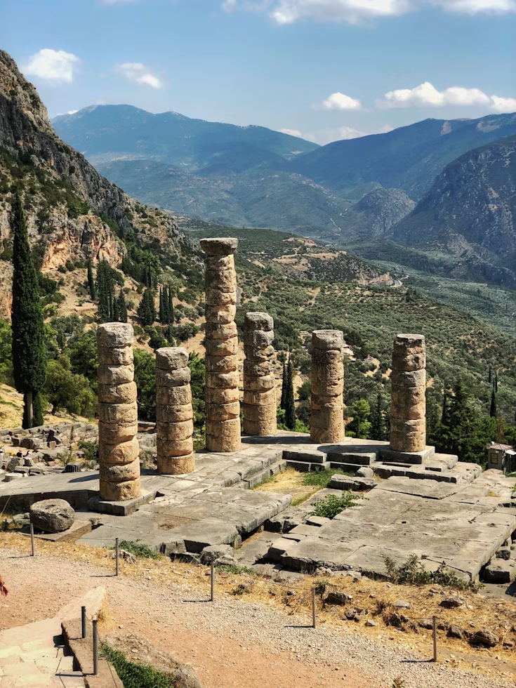 Ruins of an ancient temple at Delphi with Mount Parnassus in the background