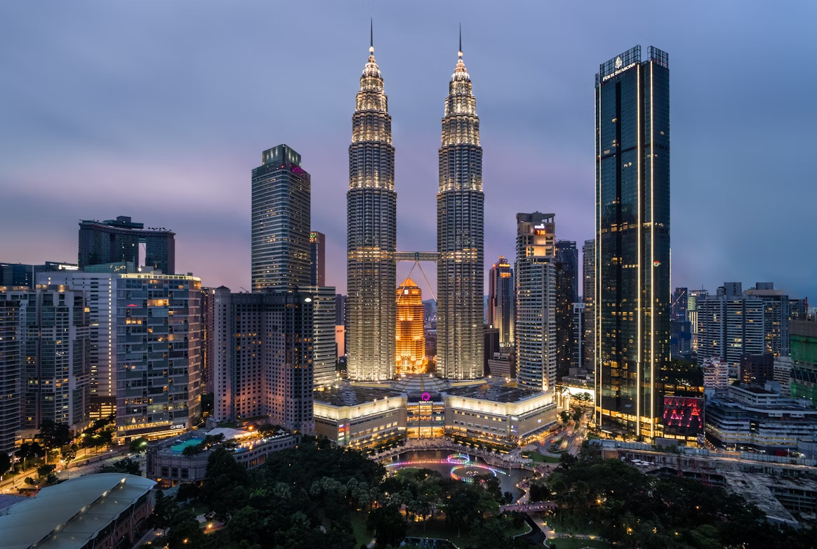 Petronas Twin Towers and Kuala Lumpur city skyline at dusk