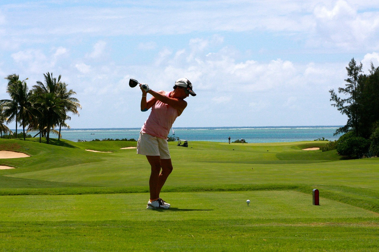 Golfer swinging on a coastal golf course