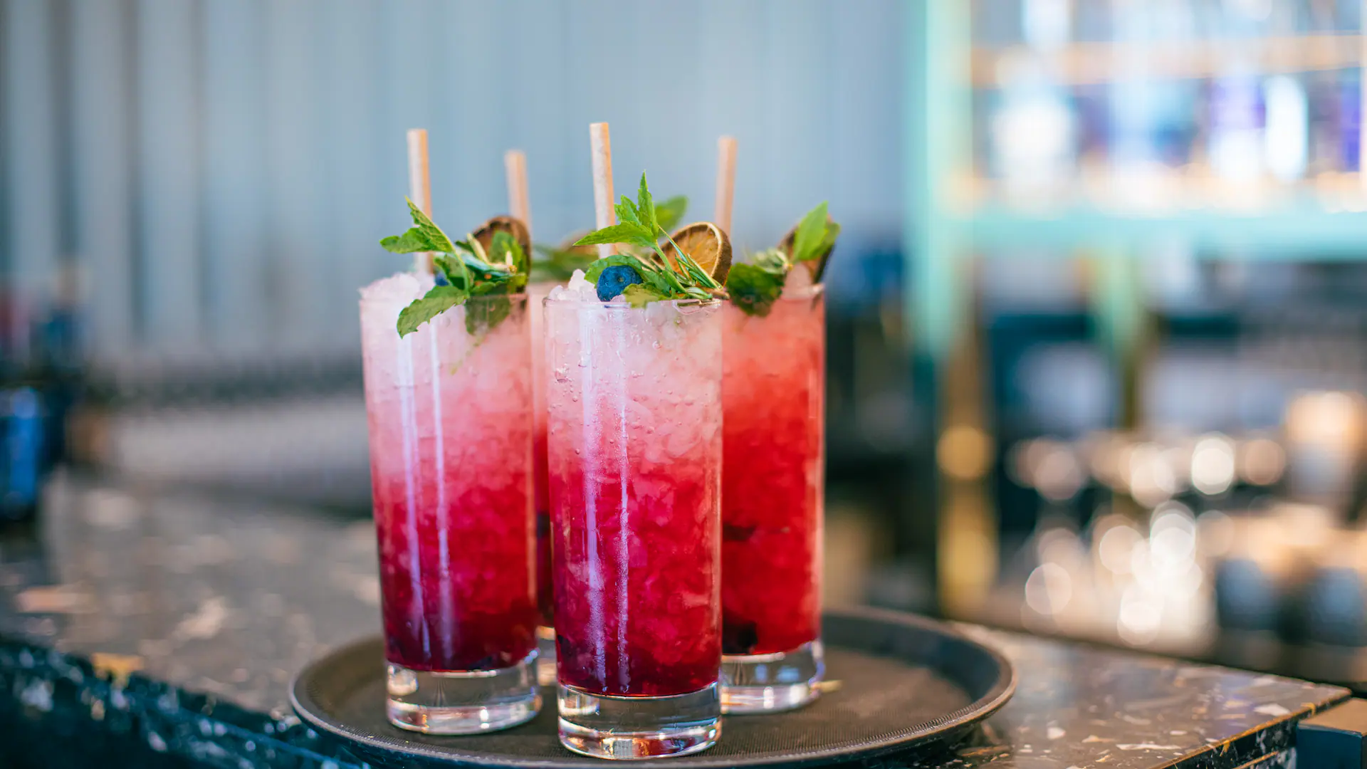 Colorful mocktails served in tall glasses at Helsinki Airport lounge bar