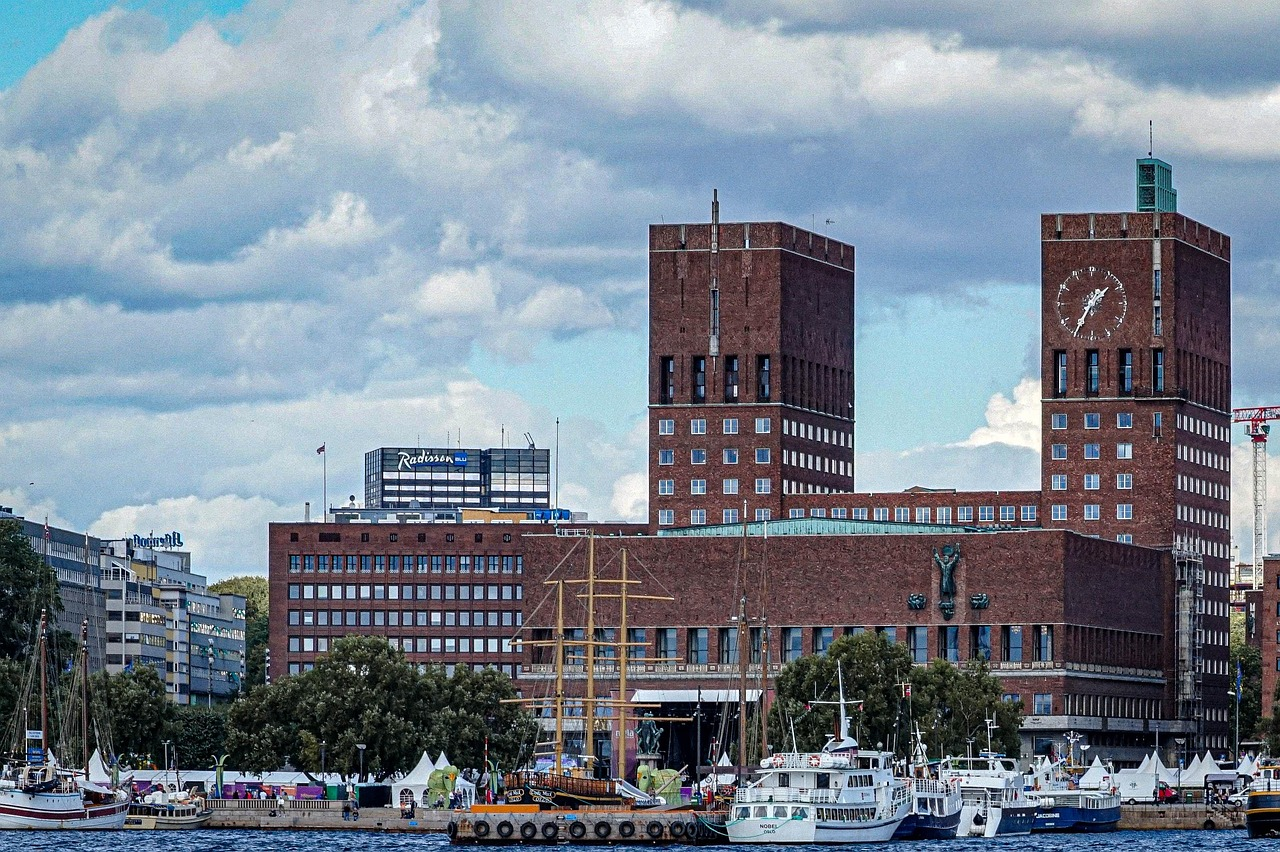 View of Oslo's Aker Brygge waterfront with boats and historic buildings