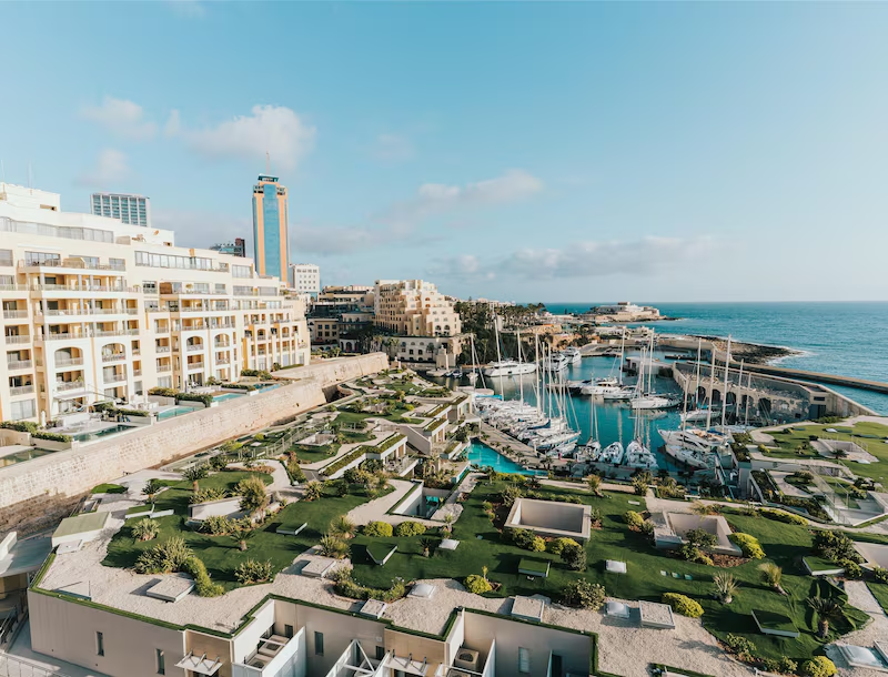 Seaside view of Cavalieri Art Hotel and marina in St Julian’s, Malta