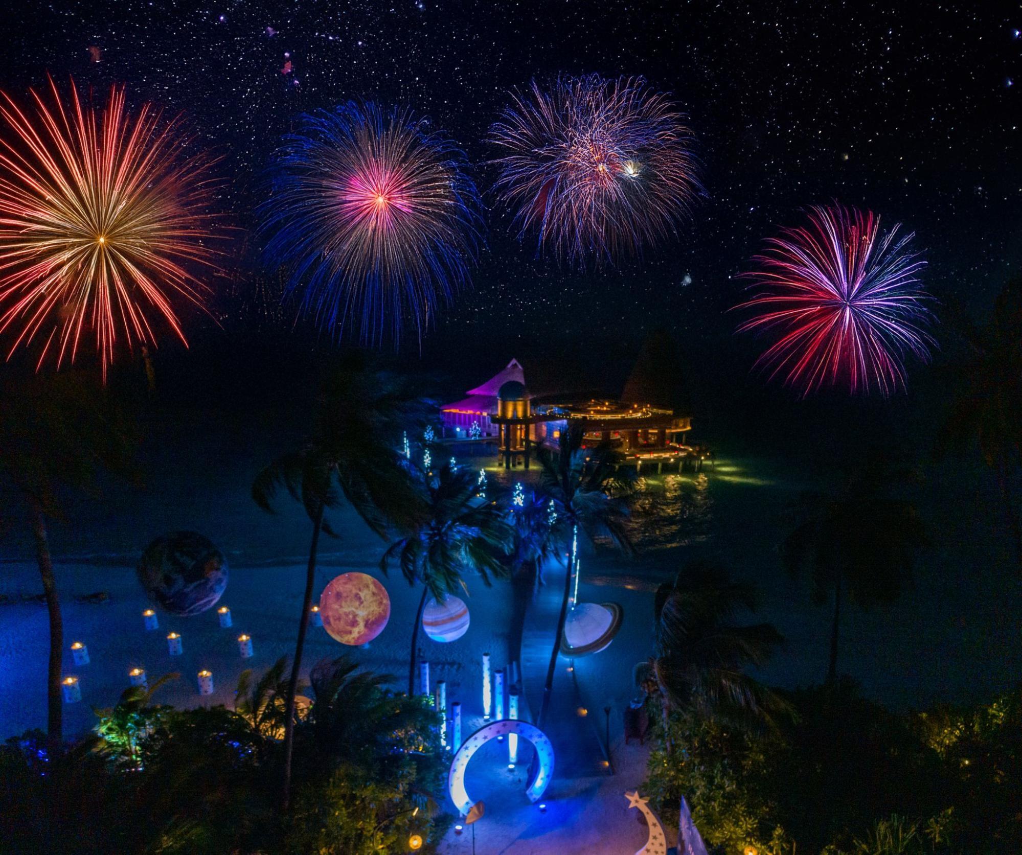 Fireworks over a festive beach celebration in the Maldives