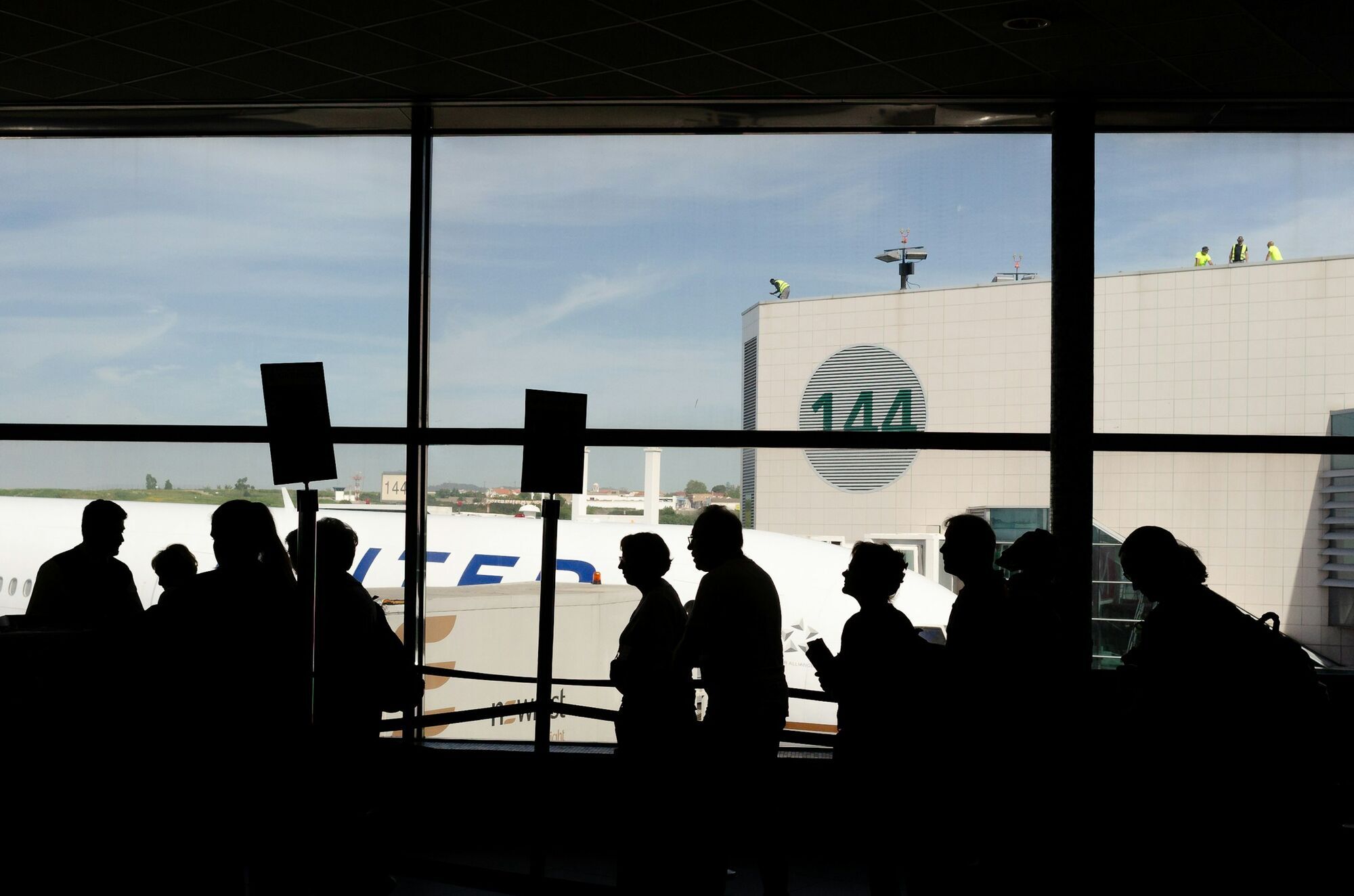 Passengers waiting at airport check-in area