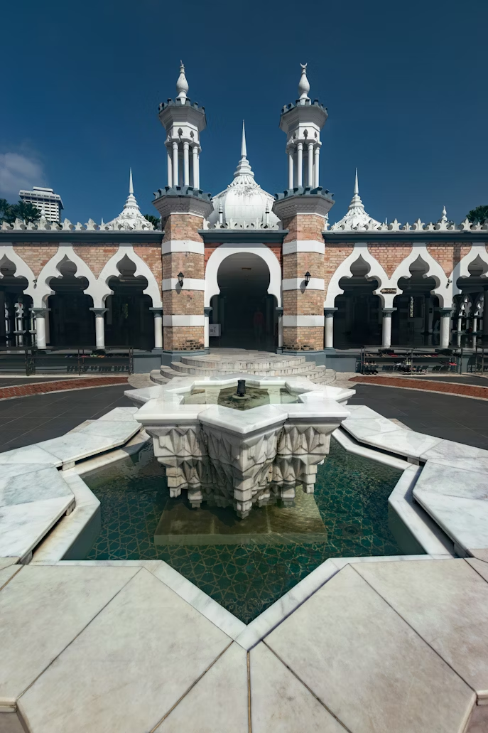 Masjid Jamek mosque courtyard with marble fountain in Kuala Lumpur