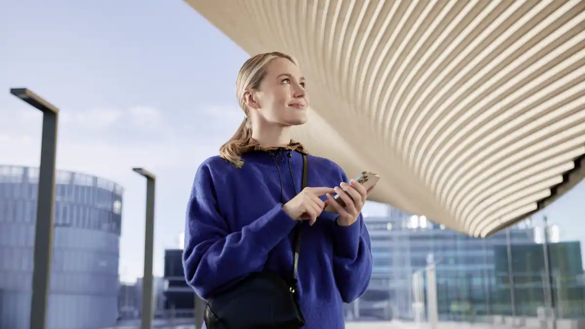 Traveler using smartphone at modern airport